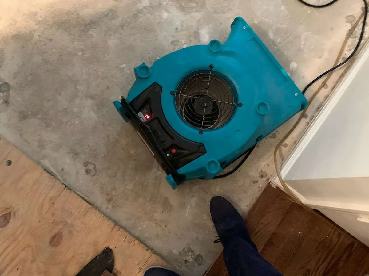 Air mover drying subfloor during Leak Detection & Repair in Old Orchard Beach